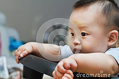 Sad cute asian baby watching out