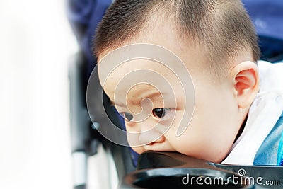 Sad cute asian baby watching out