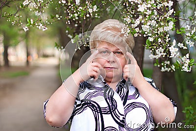 Sad elderly woman with glasses