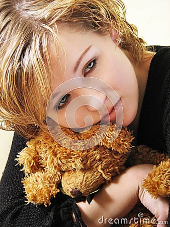 Sad girl with a teddy bear