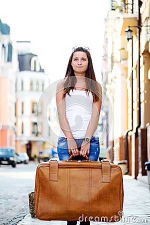 Sad looking girl with luggage