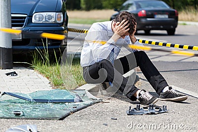 Sad man at accident scene