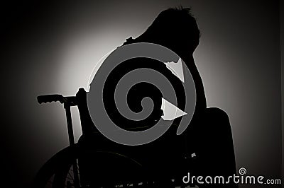 Sad man sitting on wheelchair