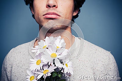 Sad and rejected man with a bouquet of flowers