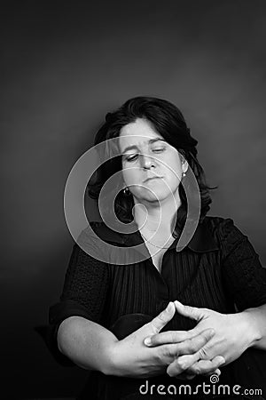 Sad and stressed hispanic woman sitting on the floor