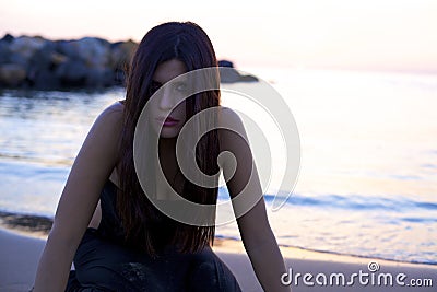 Sad woman crying on the beach