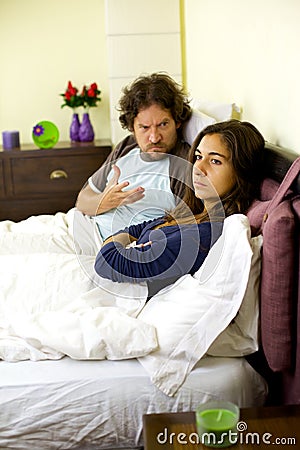 Sad woman almost crying with husband yelling at her