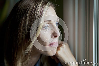 Sad woman at the window