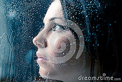 Sad Woman On Window In The Rain