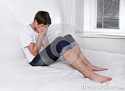 Sad Young Man on the Bed