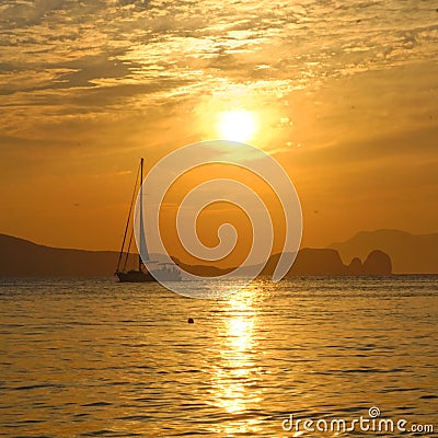 Sailboat on bay at sunset