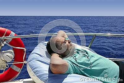 Sailor senior man having a rest on summer boat