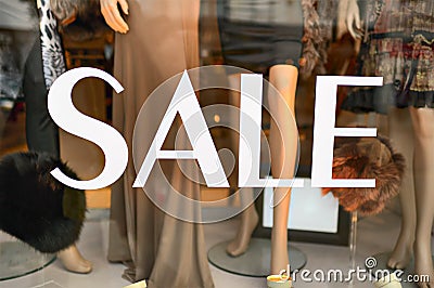 Sale sign in a fashion shop window