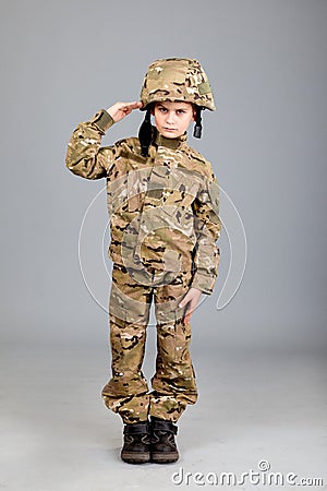 Saluting soldier. Young boy dressed like a soldier