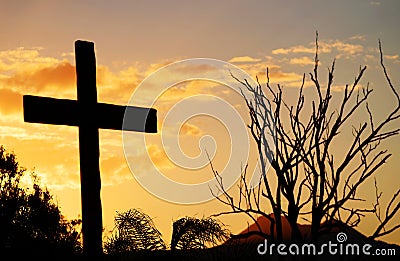 Salvation cross of Christ on hill at sunset