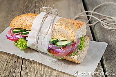 Sandwich with salami, tomato and lettuce