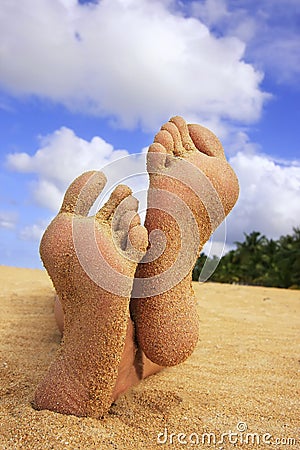 Sandy feet on a beach