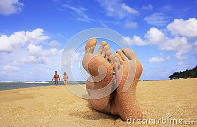 Sandy feet on a beach