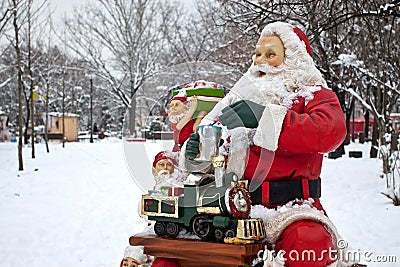 Santa claus and helpers preparing gifts