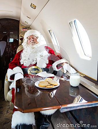 Santa With Eyes Closed Relaxing In Private Jet