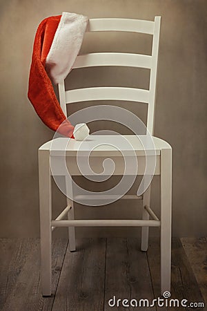 Santa Hat on chair over retro background. Christmas holiday celebration
