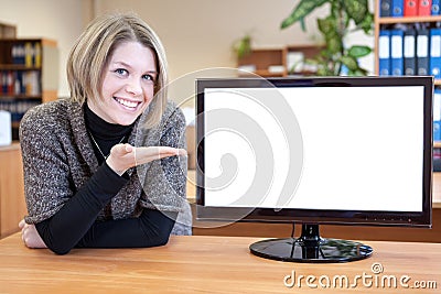 Satisfied girl is pointing at a blank monitor screen