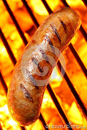 Sausage hot dog on a fire hot barbecue grill