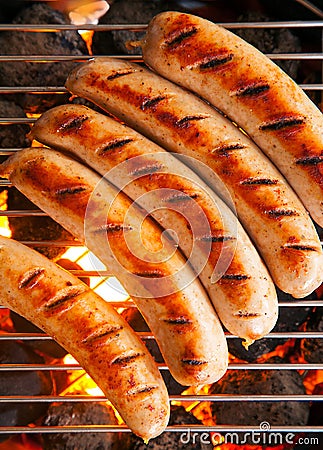 Sausages cooking on a barbecue fire