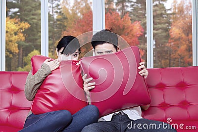 Scared couple watching halloween movie