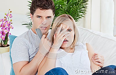 http://thumbs.dreamstime.com/x/scared-couple-watching-horror-movie-lying-sofa-16484038.jpg