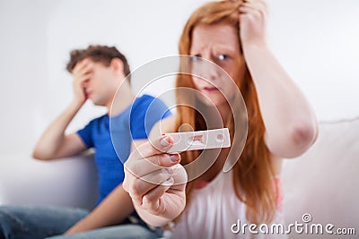 Scared teenagers with positive pregnancy test