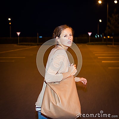 Scared young woman running from her pursuer