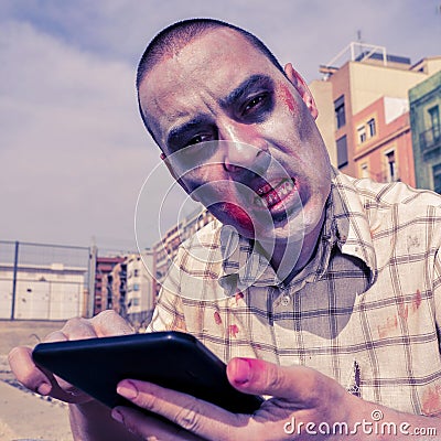 Scary zombie using a tablet computer, with a filter effect