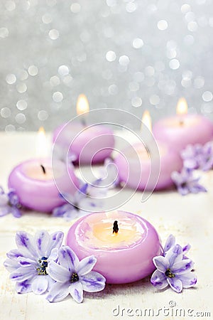 Scented candles and violet hyacinth flowers