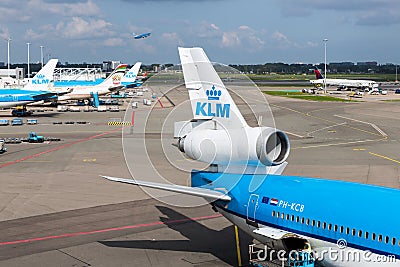 Schiphol airport with workers and departing and ar