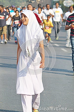 School girl running at Hyderabad 10K Run Event, India