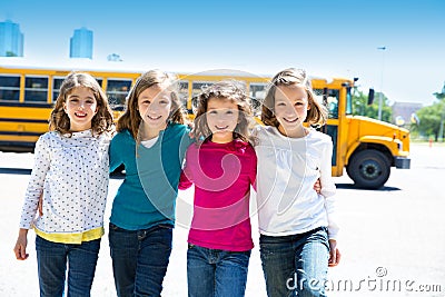 School girls friends in a row walking from school bus