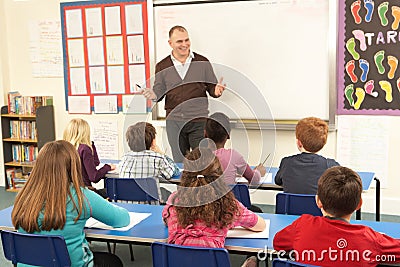 Schoolchildren Studying In Classroom With Teacher