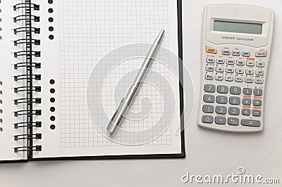 Scientific calculator next to elegant silver pen