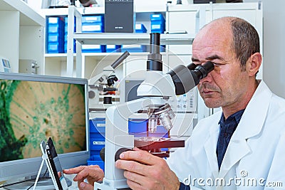 Scientist examines biopsy samples