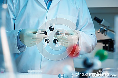 Scientist holding molecular model