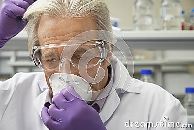 Scientist Putting On Safety Mask