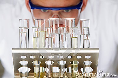 Scientist Studying Test Tubes In Rack