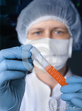 Scientist or tech holds liquid biological sample