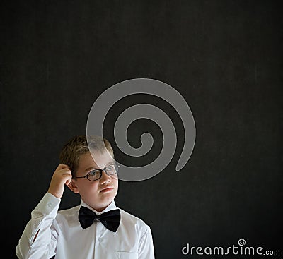 Scratching head thinking boy dressed up as business man