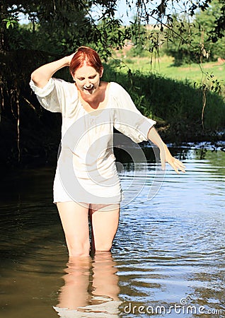 Screaming girl in blouse in water