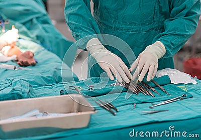 Scrub nurse prepare tools for surgery