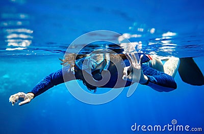 Scuba diver woman in blue water.