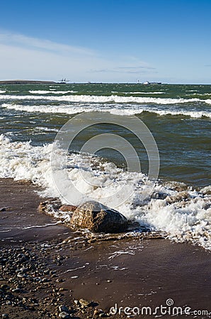 Sea waves lapping on the shore.