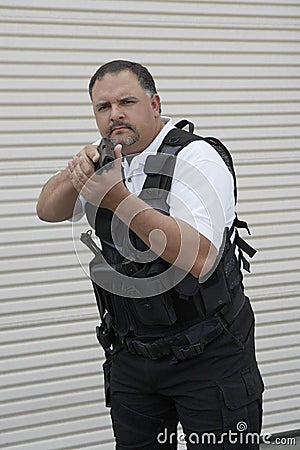 Security Guard In Bulletproof Vest Holding Gun